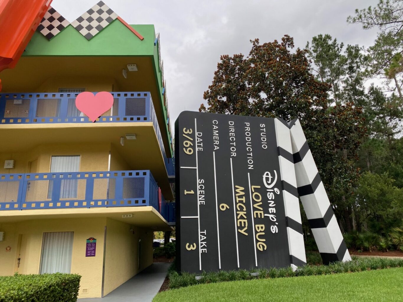 colorful hotel building next to giant black clapboard disney world resorts