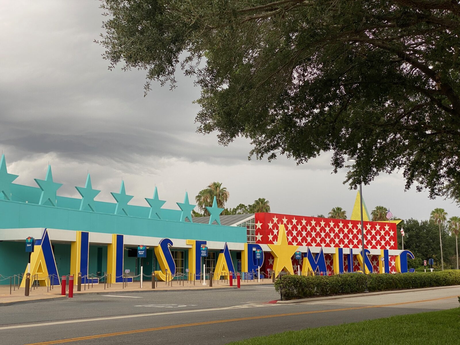 front of colorful hotel with all star music sign Disney World resorts 