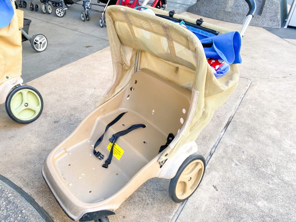 A photo of a Disney double stroller: when considering Disney with toddlers, look at the type of strollers-- this one is hard and plastic.