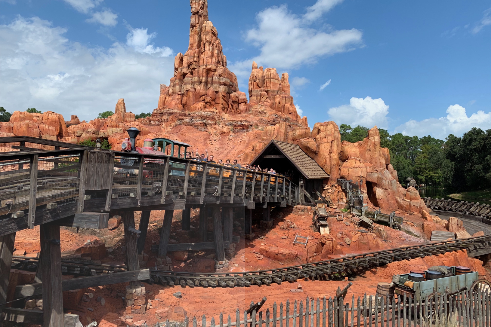 ground view of the train on the Big Thunder Mountain Railroad as it travels over the tracks
