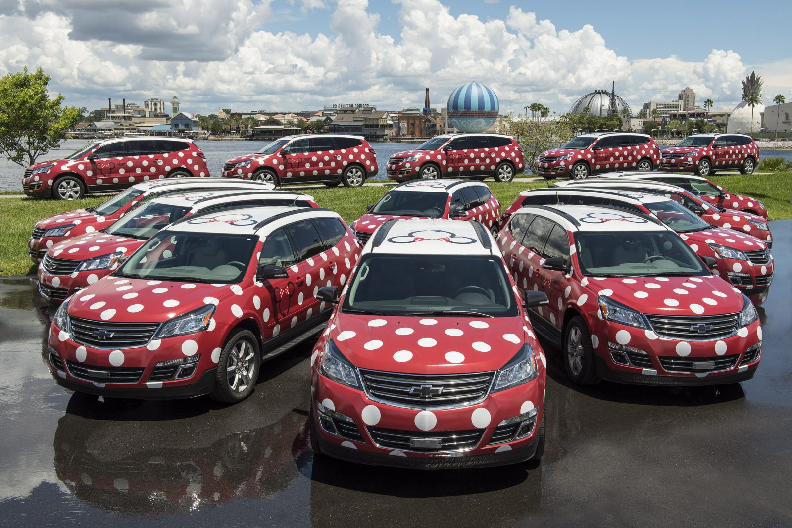 photo of a fleet of red vans with white Minnie spots; tipping at Disney