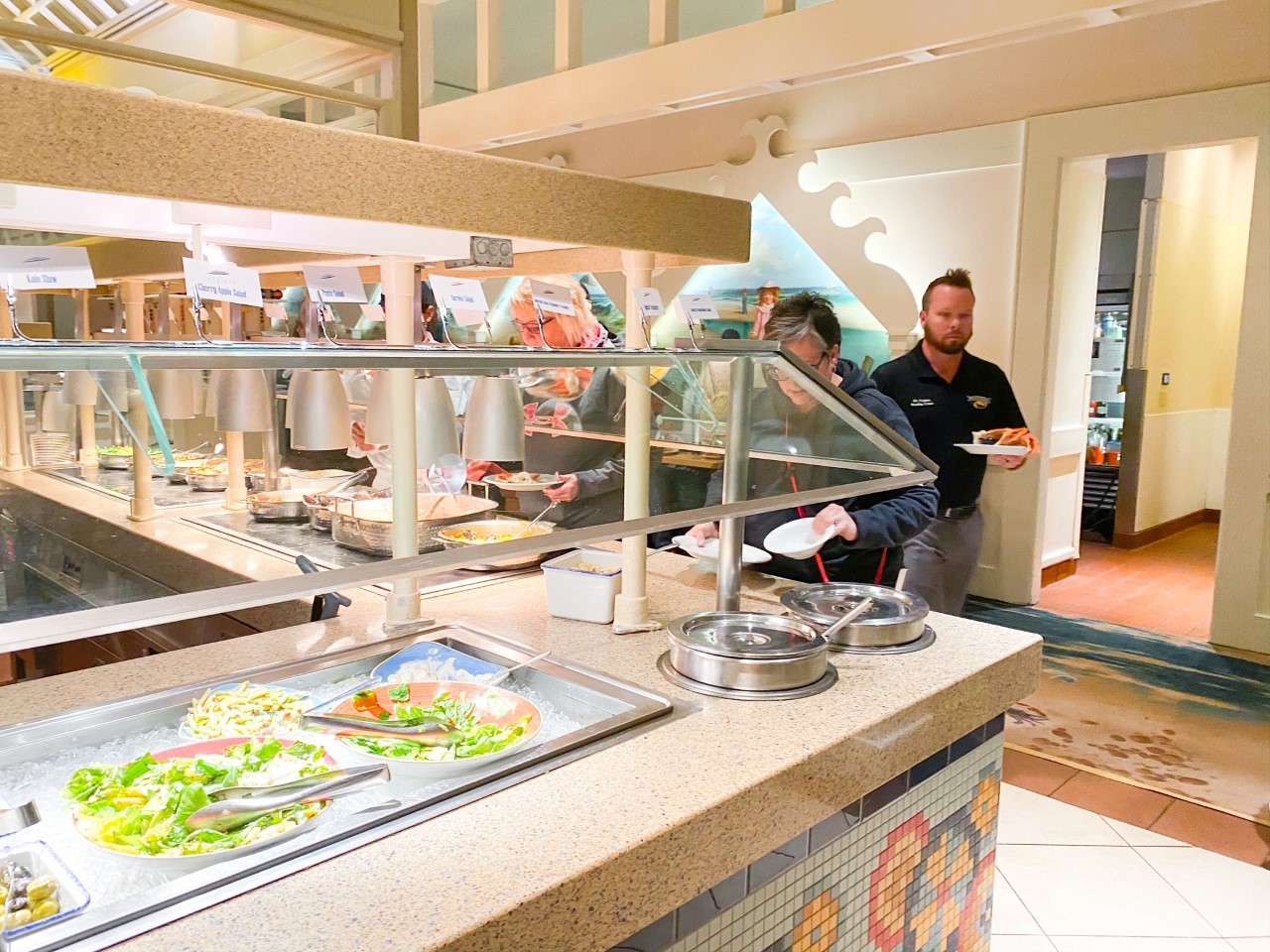 photo of people serving themselves at a buffet restaurant, tipping at Disney