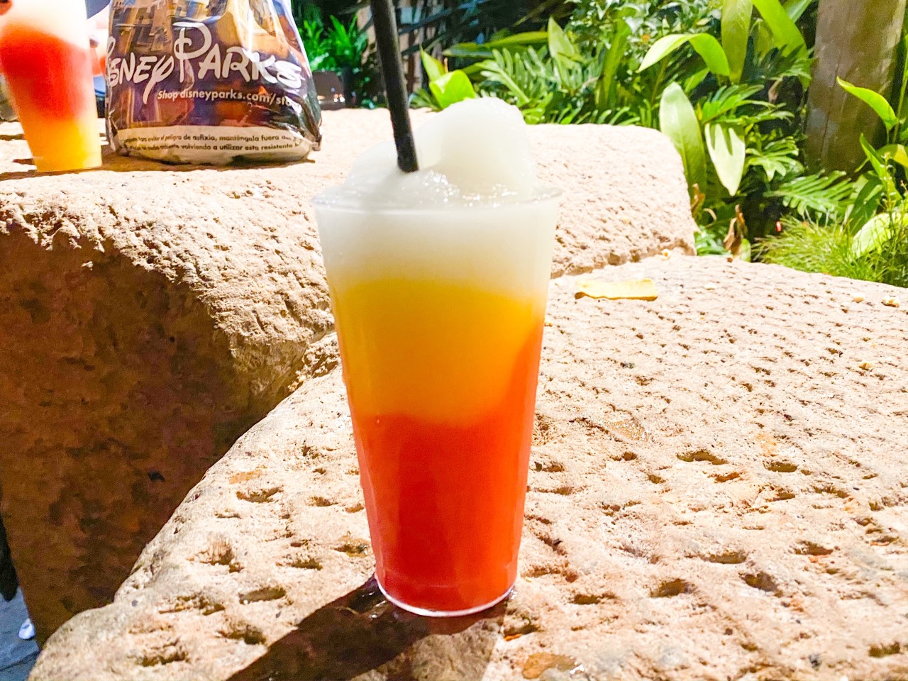 photo of a beautiful, colourful drink at Disney; tipping at Disney