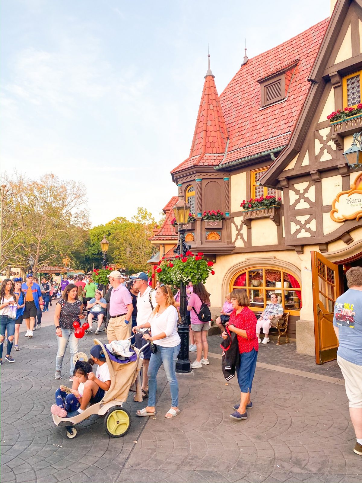 Guests walk around Epcot in crowds, with strollers. Strollers at Disney help navigate these spaces. 