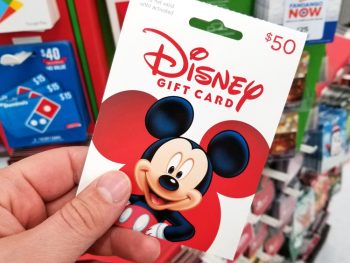 Photo of person holding discount Disney gift card.