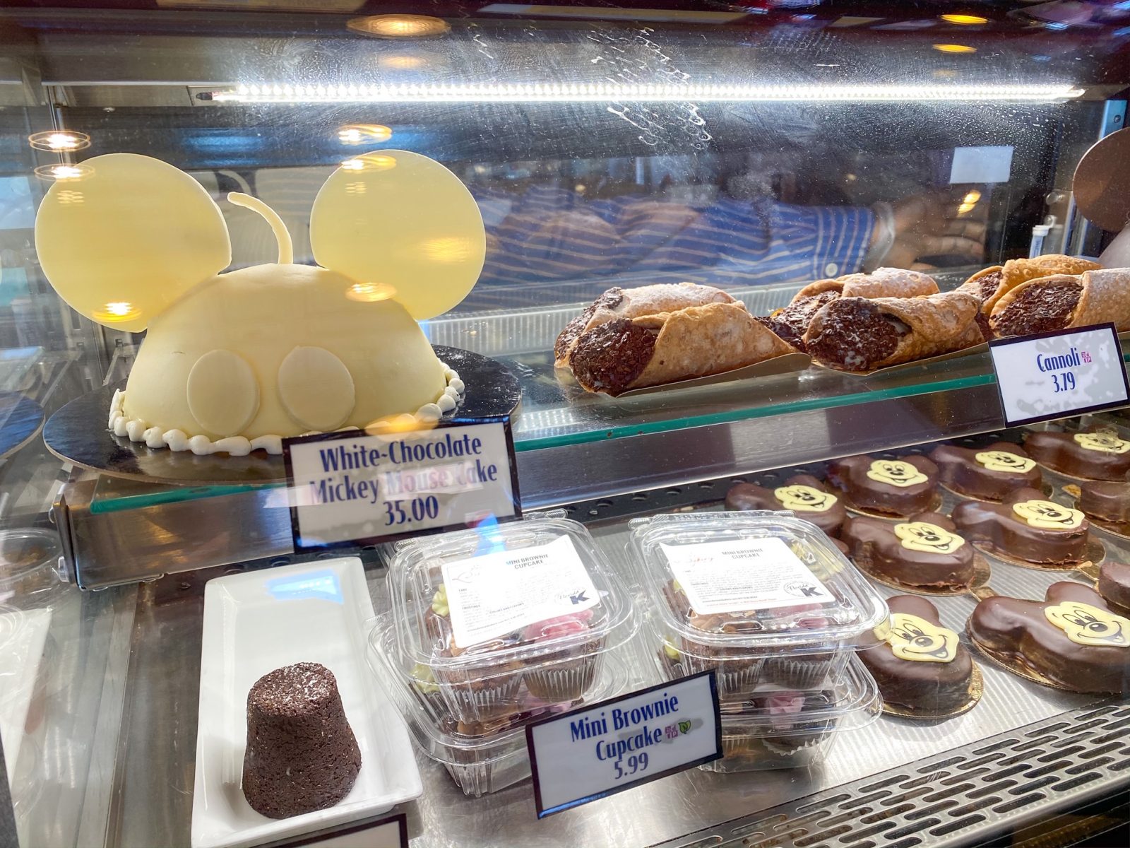mickey shaped cake and chocolate desserts in case with snack credits Disney dining plan
