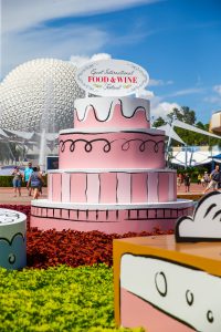giant pink paper cake at entrance of Epcot