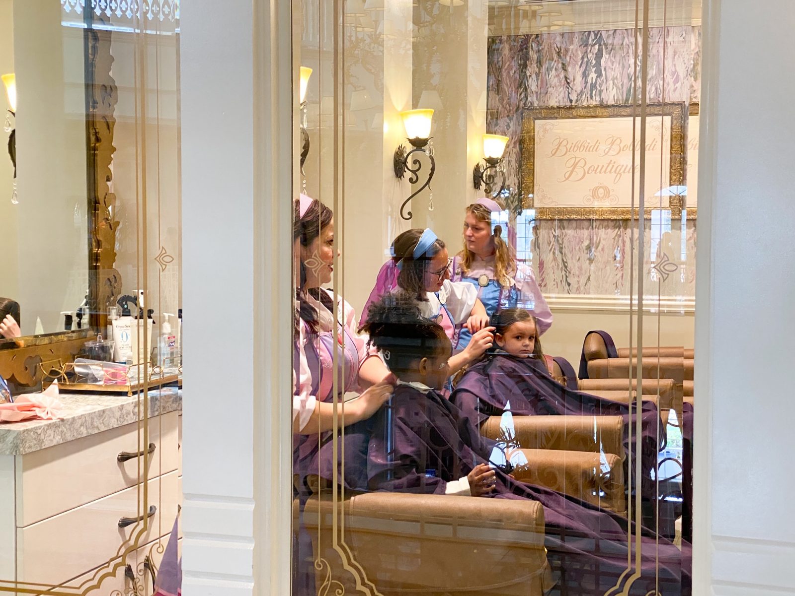 girls getting their hair and make up done at Bibbidi Bobbidi Botique