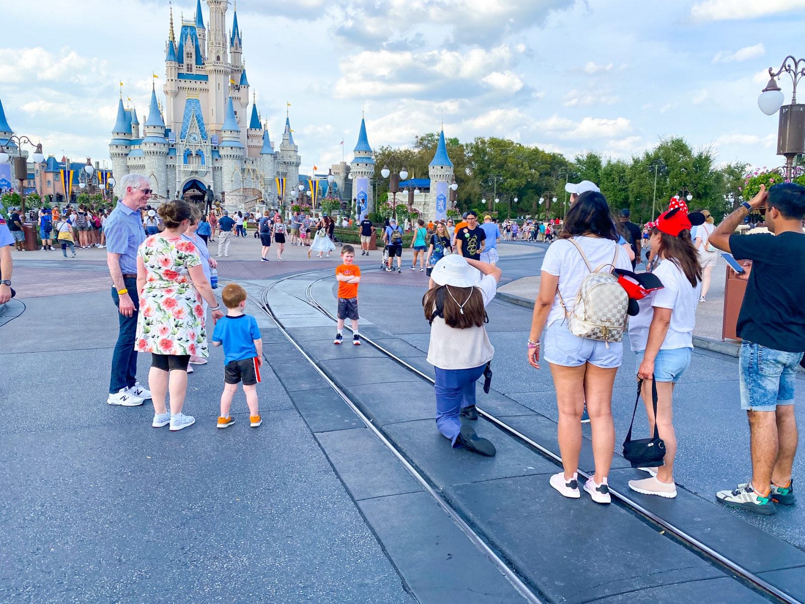 kid getting his picture taken in front of Cinderella's Castle