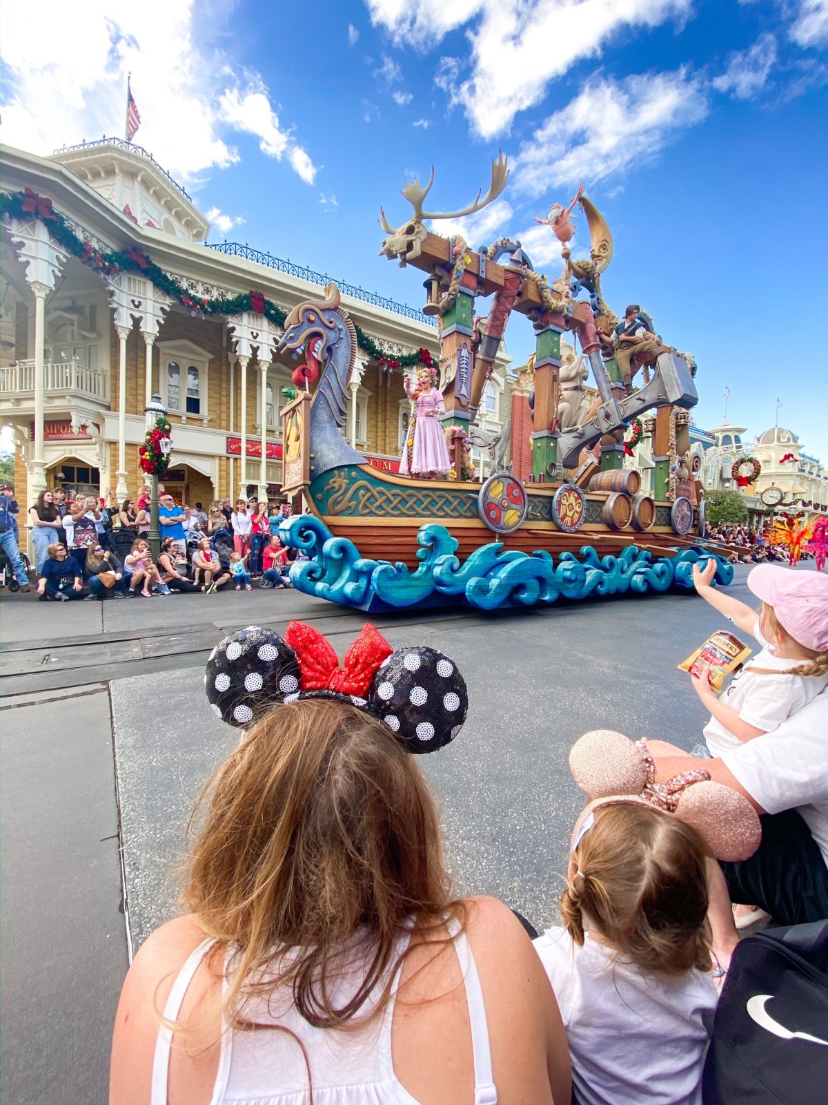 people watching the parade pass by on Main Street