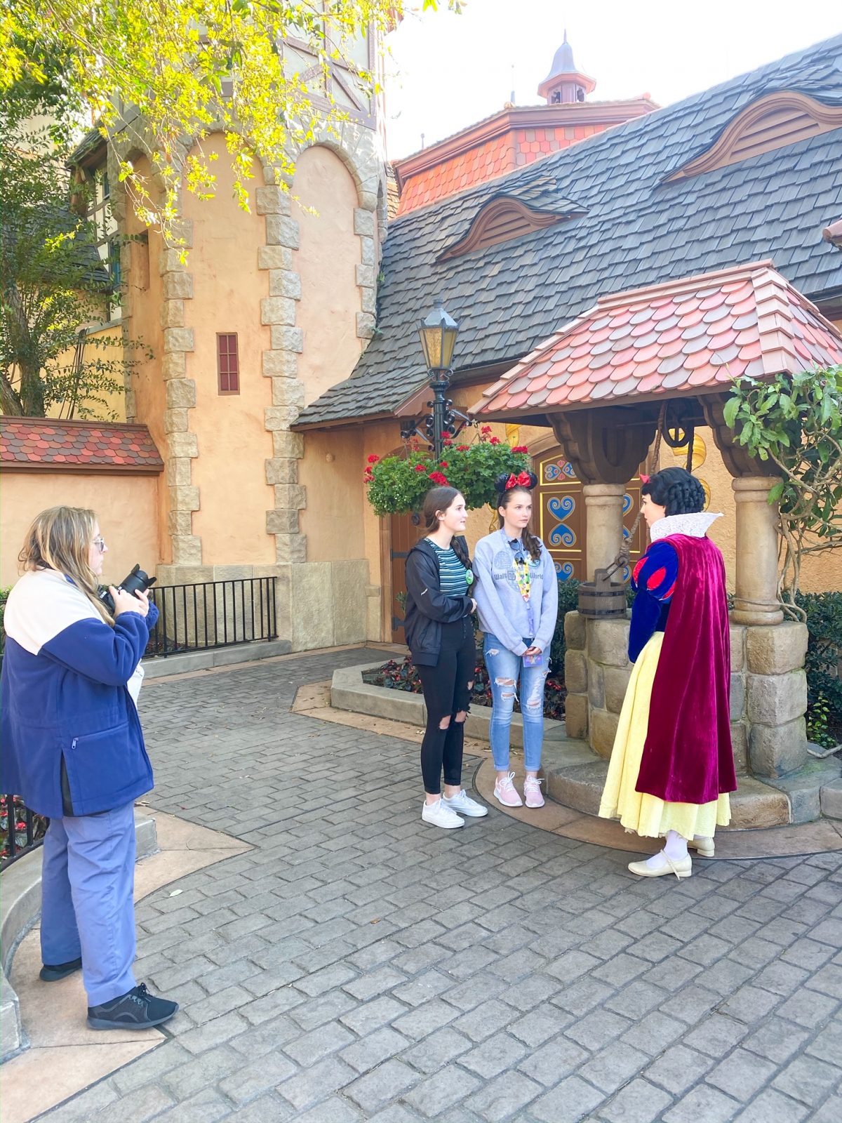 teens meeting and taking a picture with Snow White