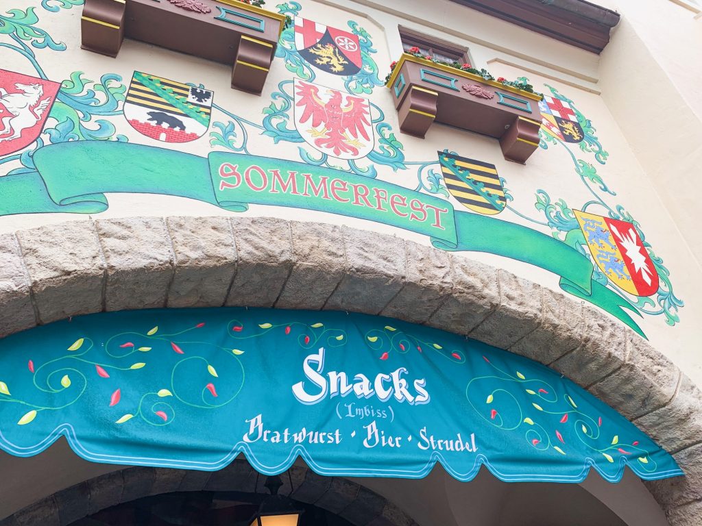 green and blue sign for German restaurant on Disney dining plan