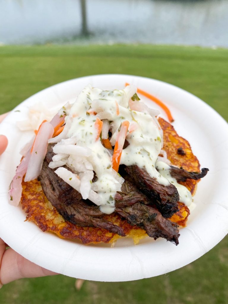 plate with meat, slaw and sauce on it 