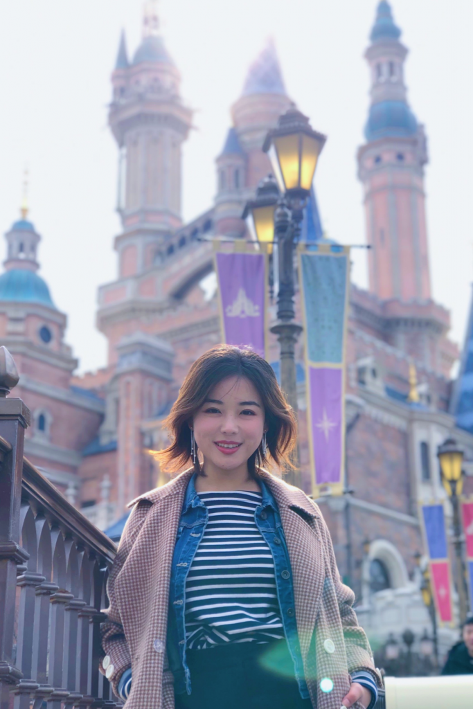 girl posing in front of the Shanghai Disneyland castle 