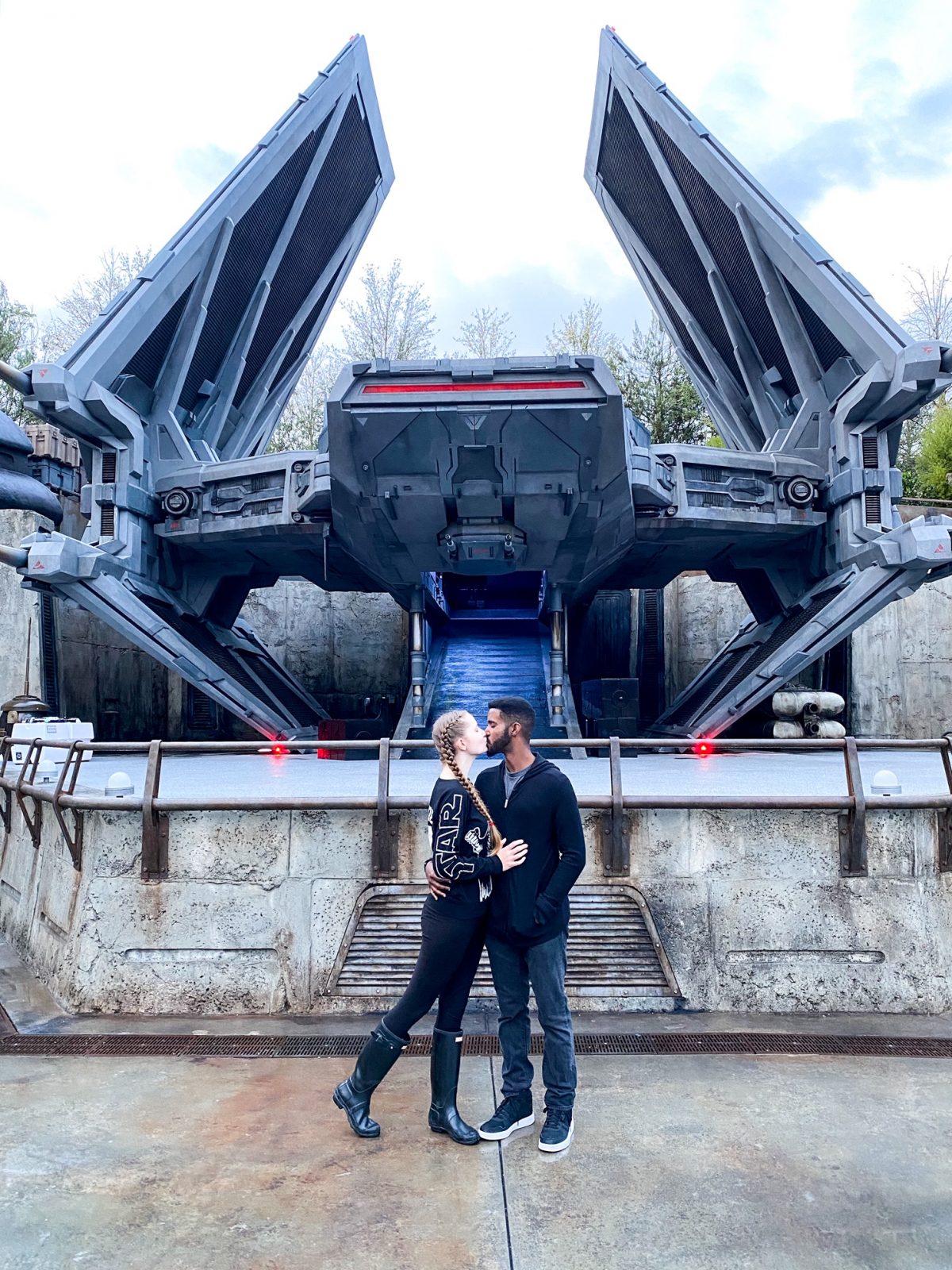 Victoria and Terrance kissing in font of Galaxy's Edge, another iconic location for Disneys Memory Maker 