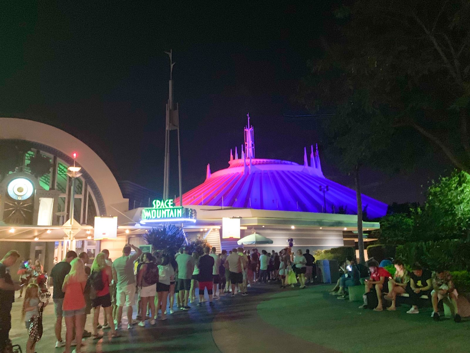 outside view of a line in front of Space Mountain at night