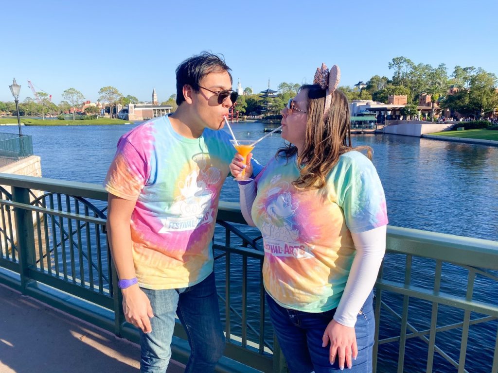 image of a couple in matching his and hers t-shirts sharing a drink - disney packing list