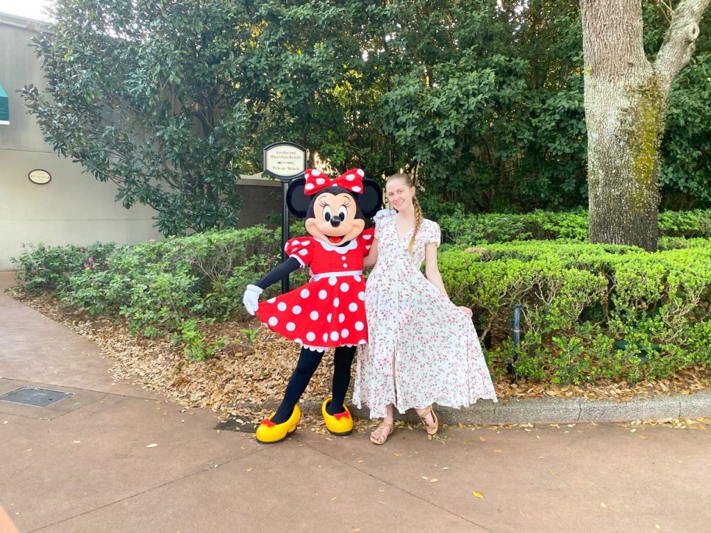 photo of woman with Minnie Mouse; add a flash drive to your Disney packing list