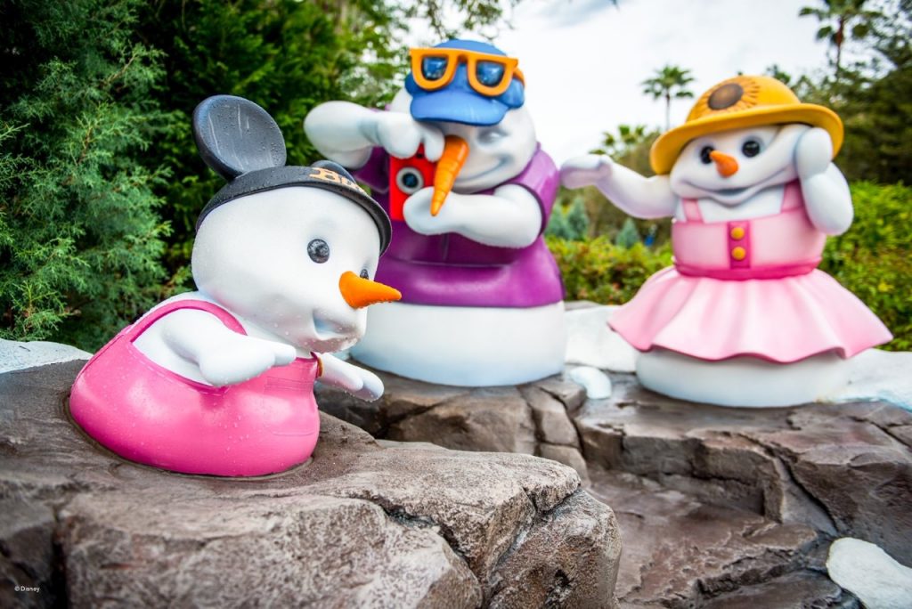 photo of snow characters having fun at Blizzard Beach- will the ski resort theming end your Blizzard Beach vs Typhoon Lagoon debate?