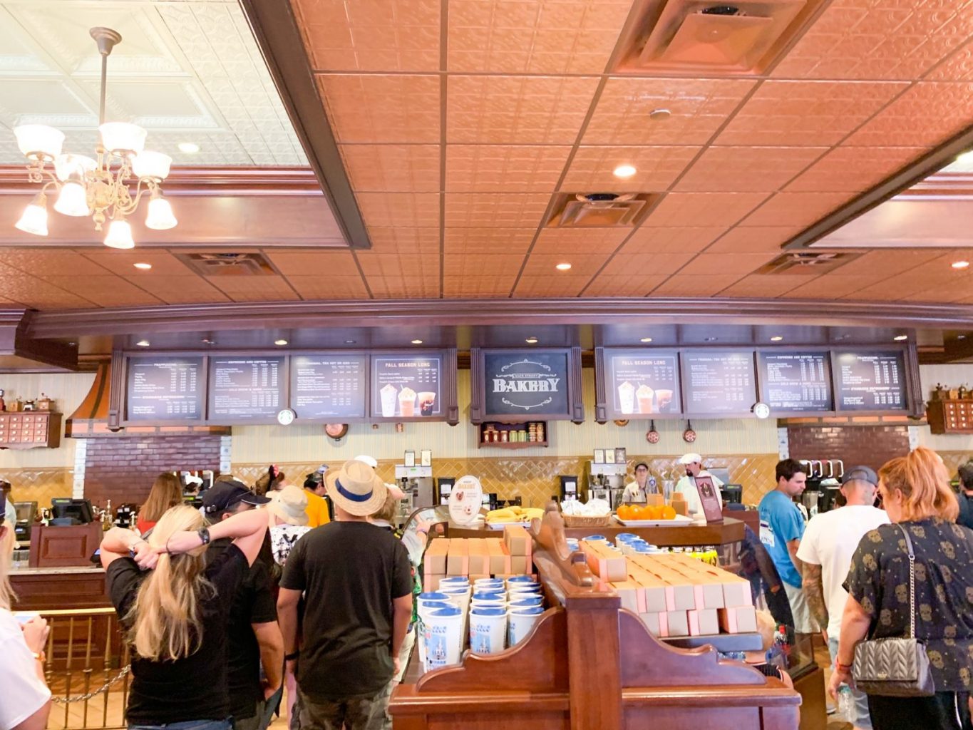 The inside of Main Street Bakery in Magic Kingdom is designed to look like a turn of the century space complete with rich golden colors and an airy atmosphere. 