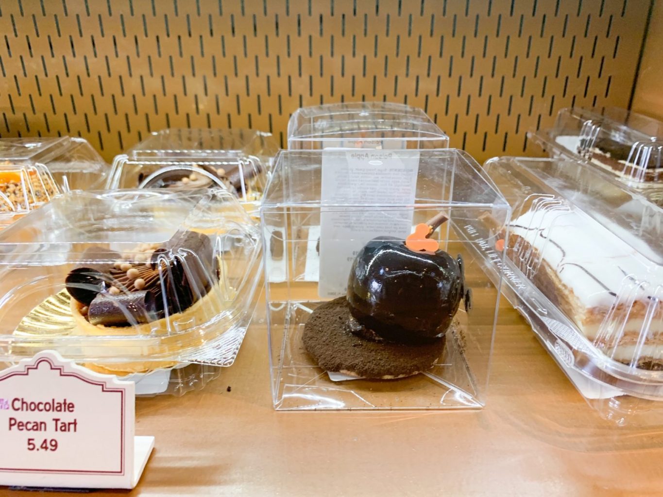 A decadent chocolate dessert pastry rests on a Starbucks shelf.