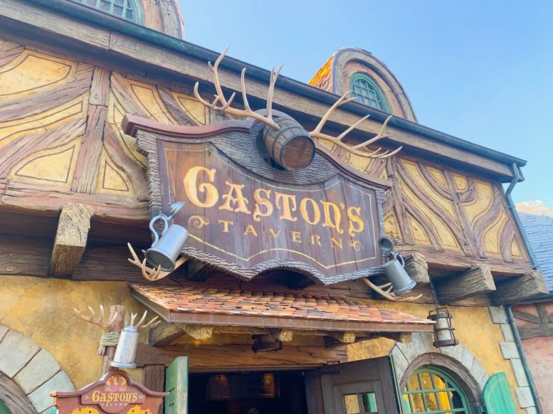store front with wooden sign with antlers for Gastons tavern magic kingdom breakfast 