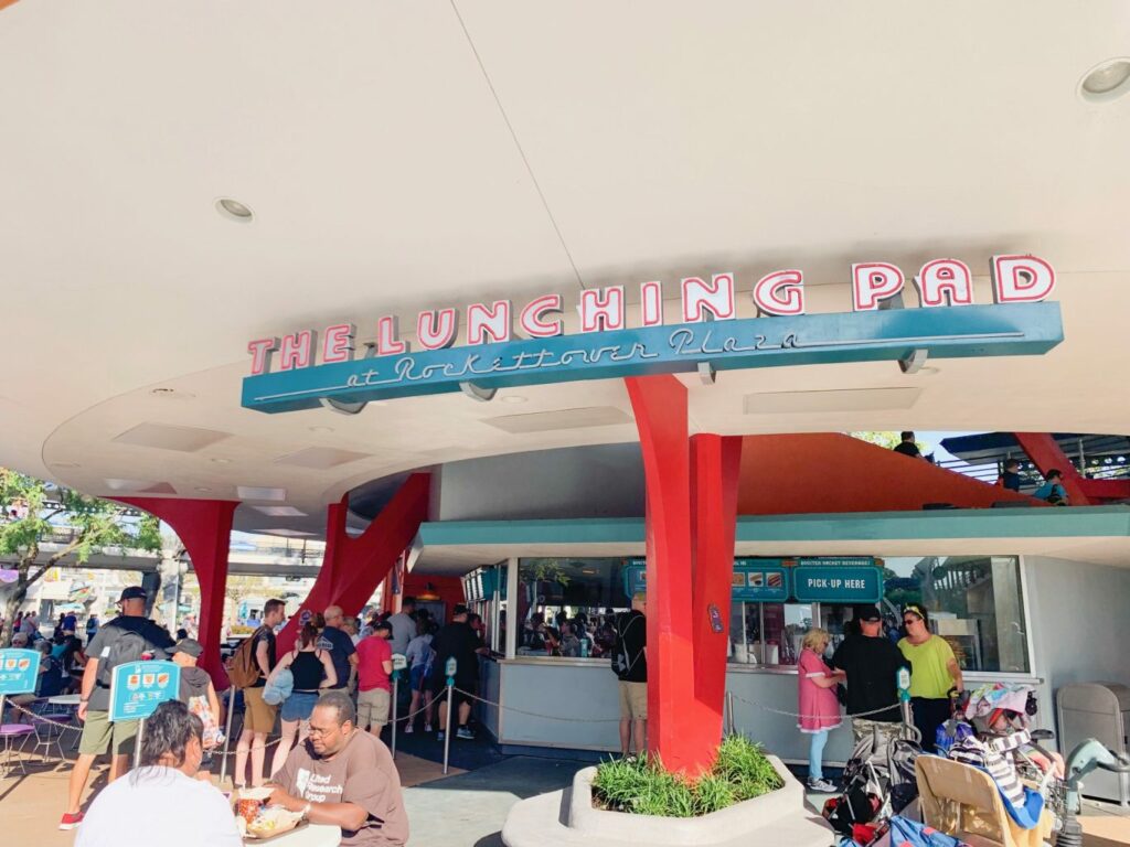futuristic blue and red sign for lunching pad magic kingdom breakfast