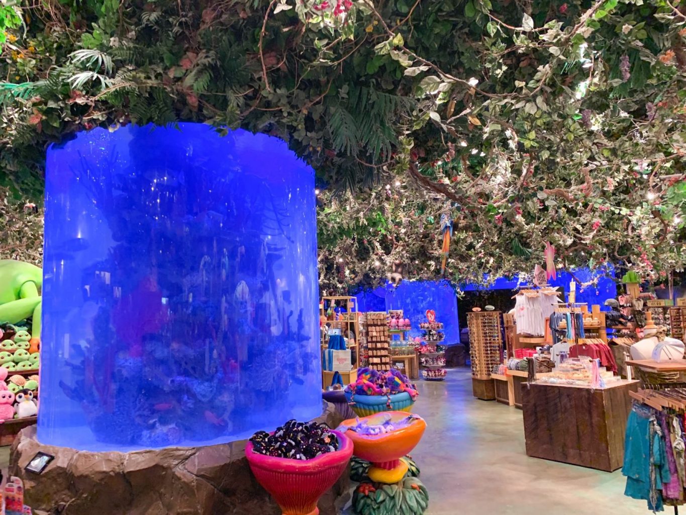 animal kingdom breakfast rainforest cafe with plants coming down from ceiling in gift shop area