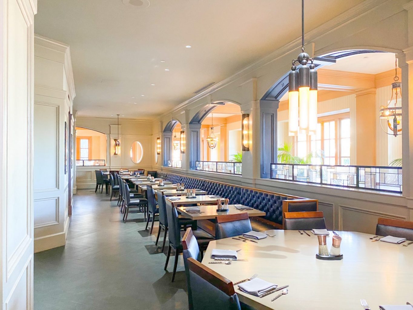 blue and wooden tables and chairs in white elegant restaurant 