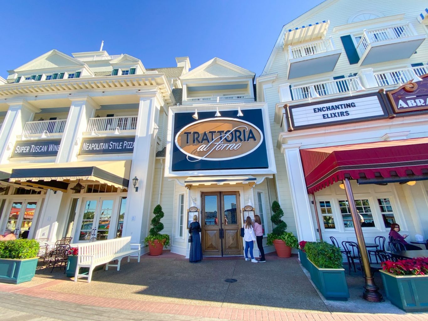 white boardwalk style building with sign for trattoria al forno restaurant best breakfast at hollywood studios 
