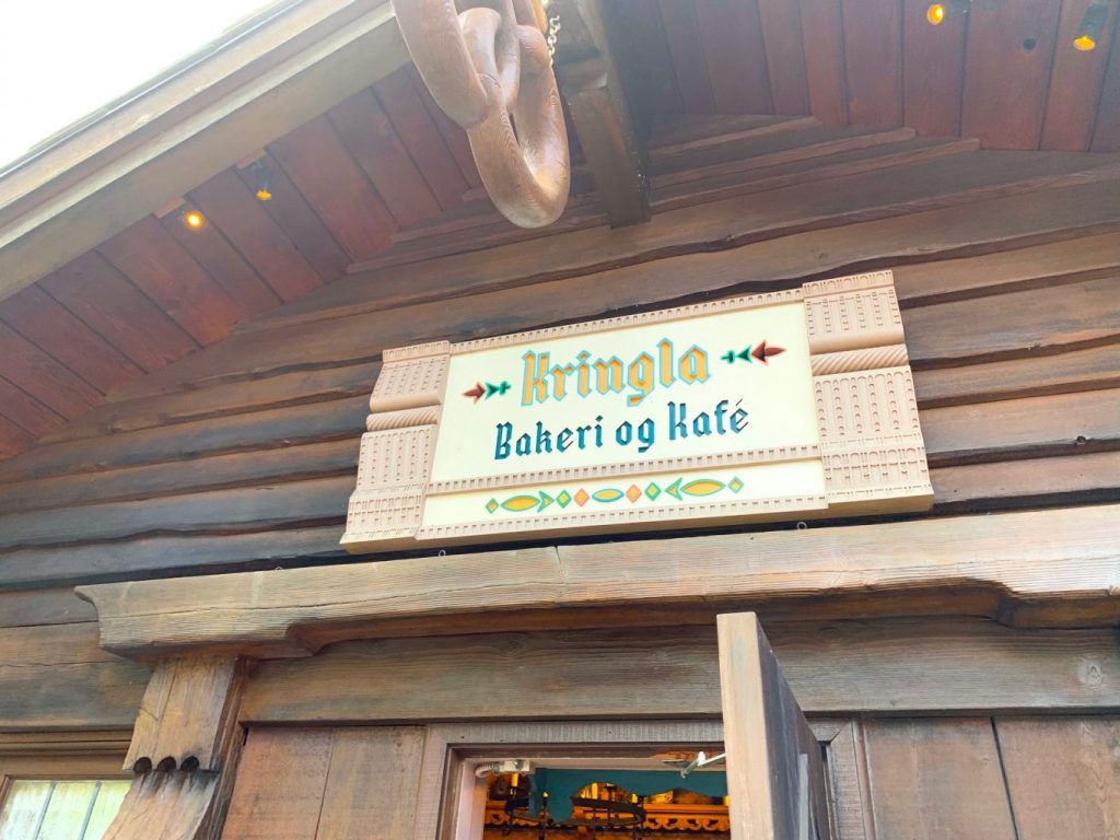 wooden sign with flowers for Kringle bakeri og kafe on wooden building 