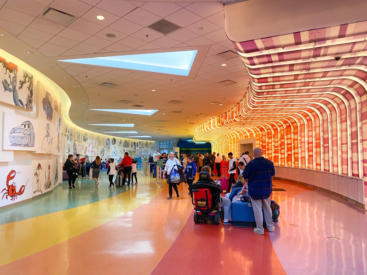 view of the Art of Animation lobby with cartoon drawings on the wall and bright lights