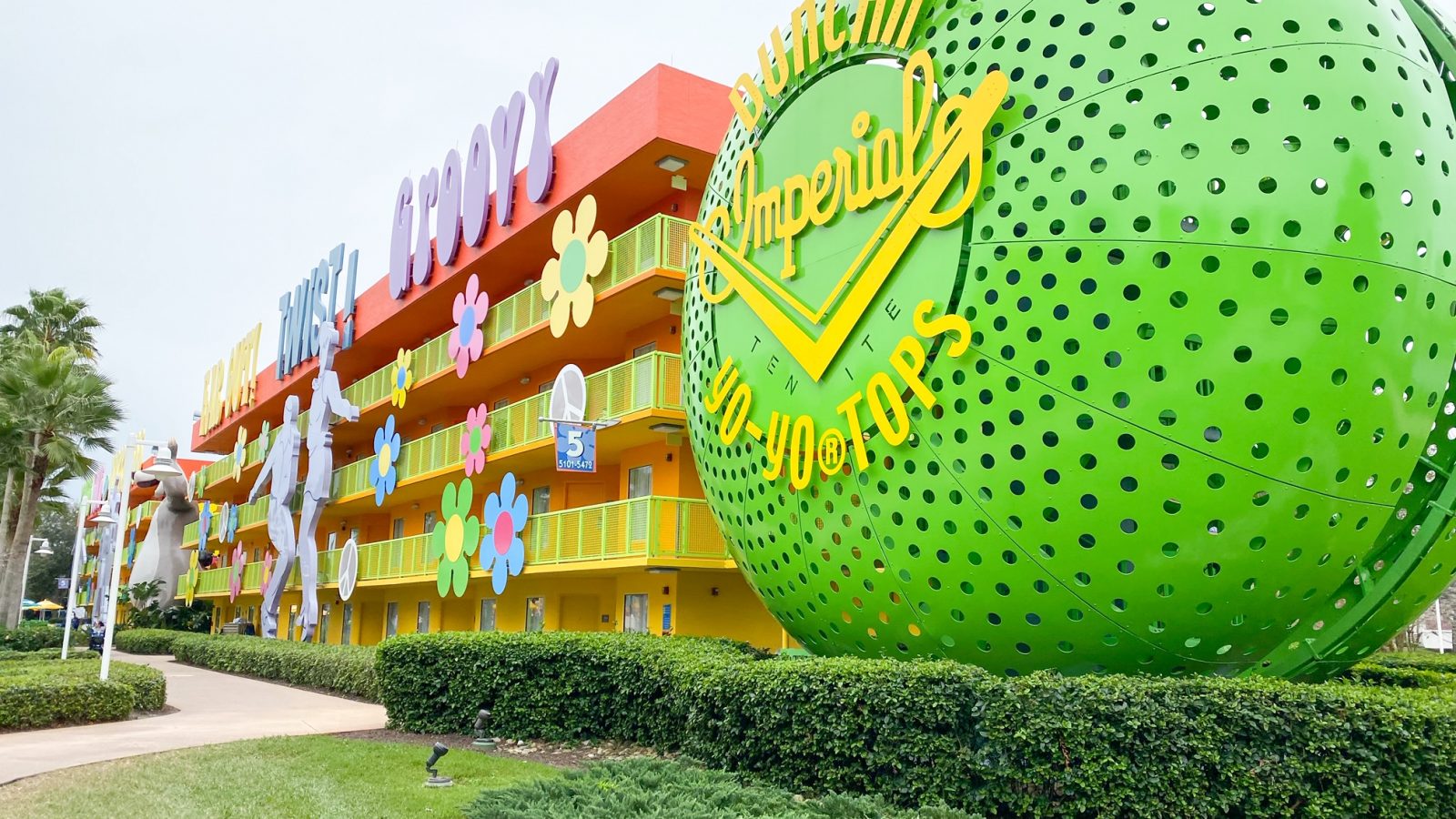 outside view of the 60's rooms at Pop Century where the staircases are encased in a giant yo-yo