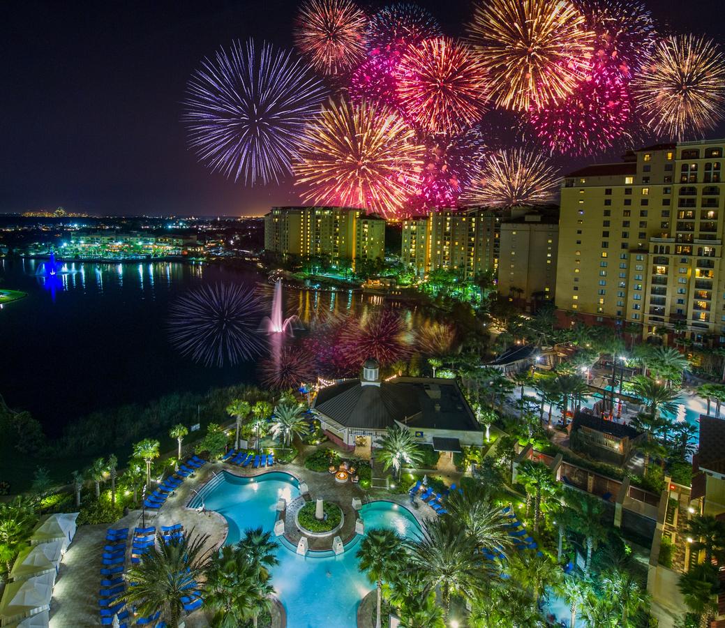 best hotels near Disney Wyndham grand Bonnet resort outside view of pool, resort, and fireworks in the distance