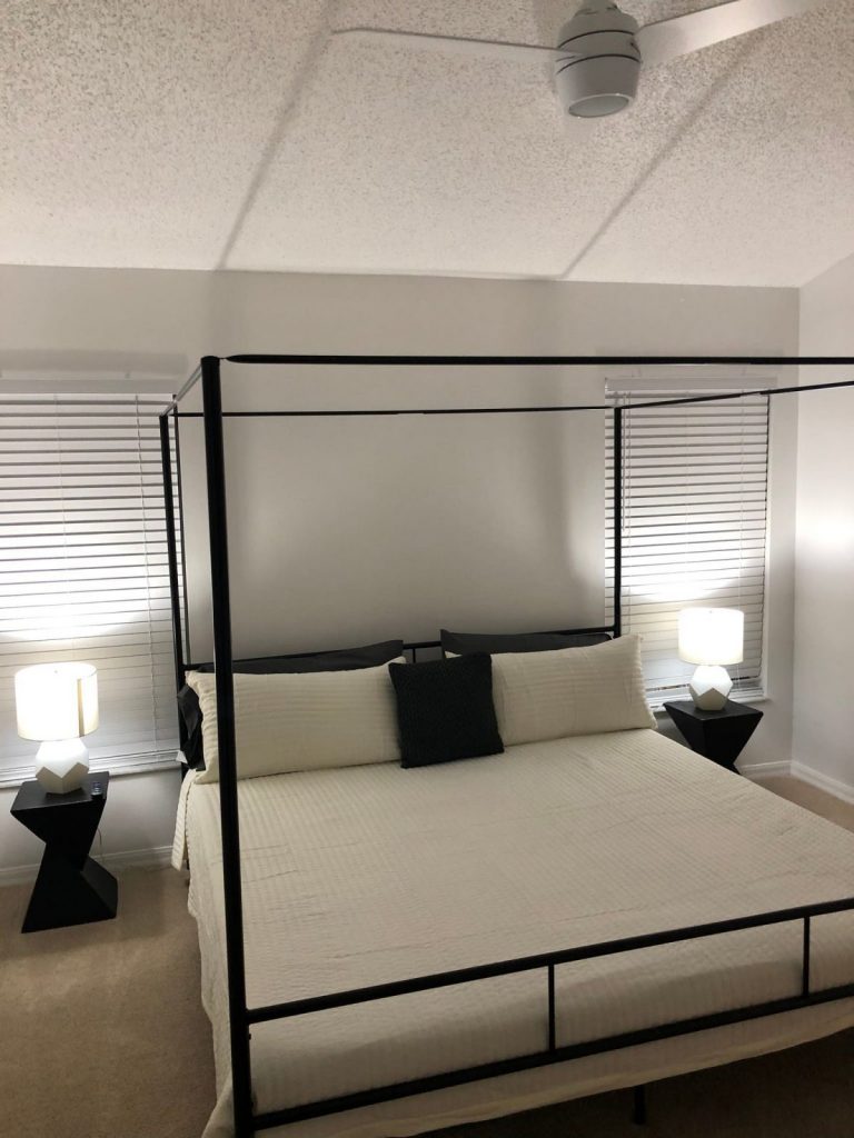 view of the bed in the bedroom in the Canopy King Suite Airbnb