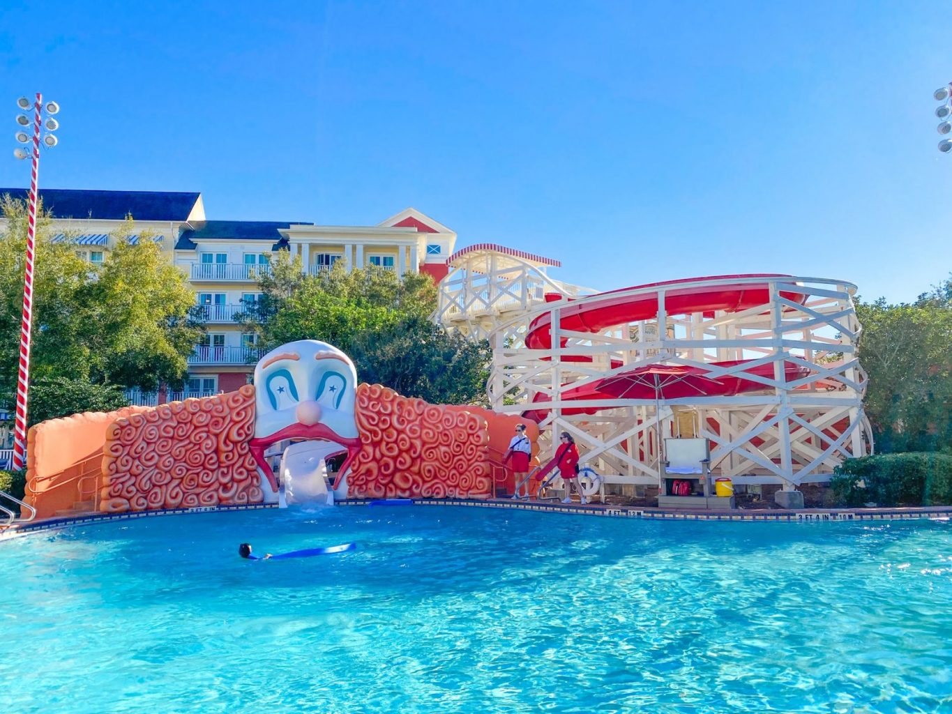 view of the wooden roller coaster water slide and giant clown at the boardwalk pool