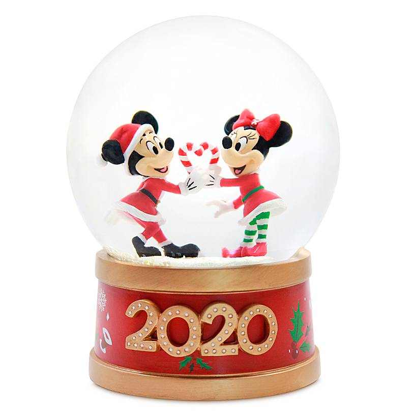Mickey and Minnie Mouse inside a snow globe holding two candy canes to make a heart