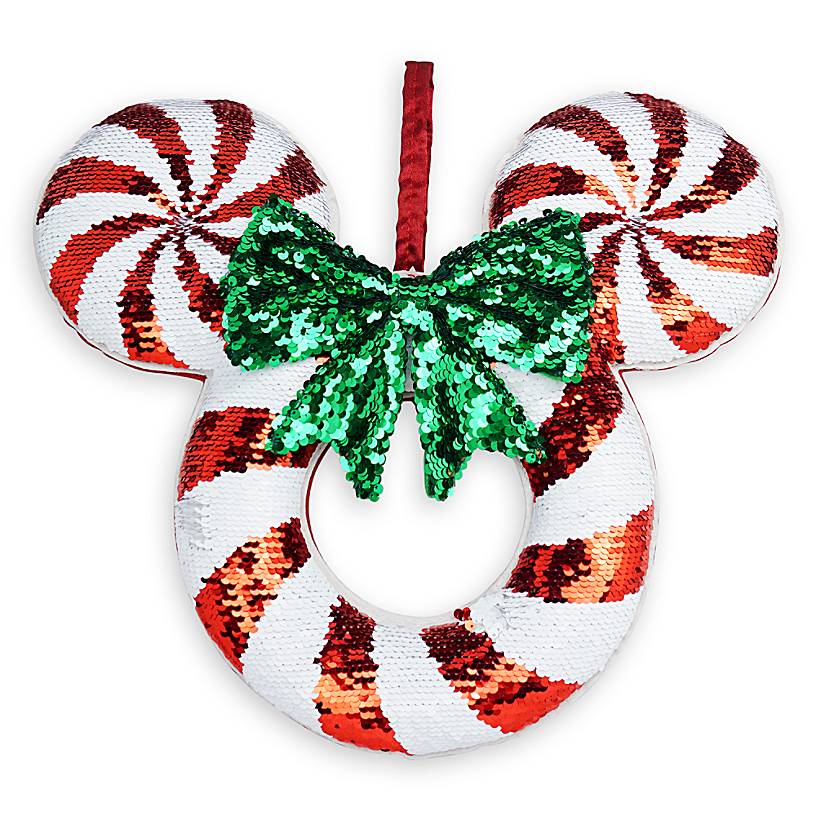Mickey mouse shaped wreath that has a peppermint pattern and a green bow