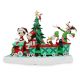 Mickey Mouse and his friends ride on a Christmas train figurine in front of a Christmas tree