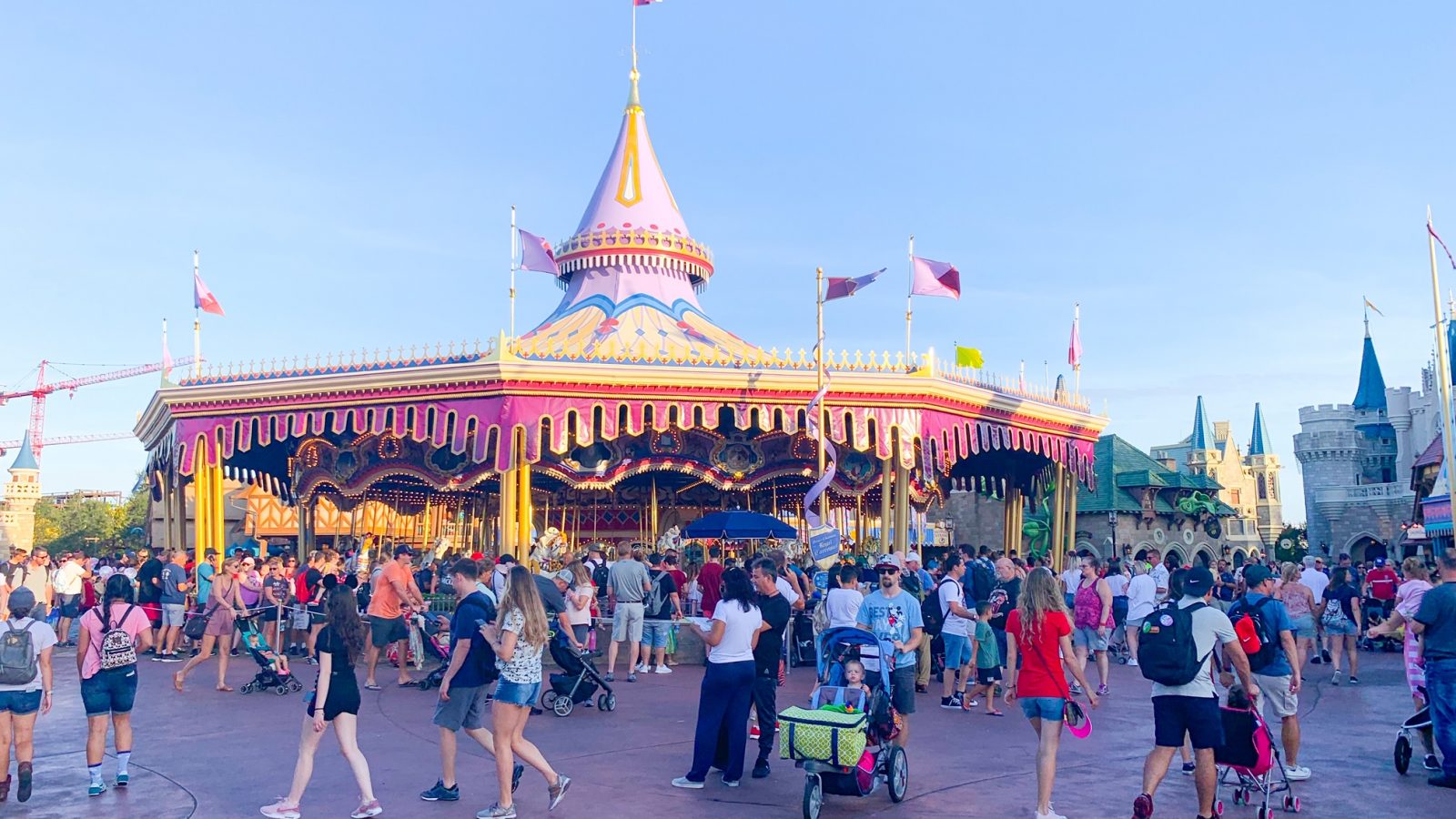 people walking in front of prince charming carousel