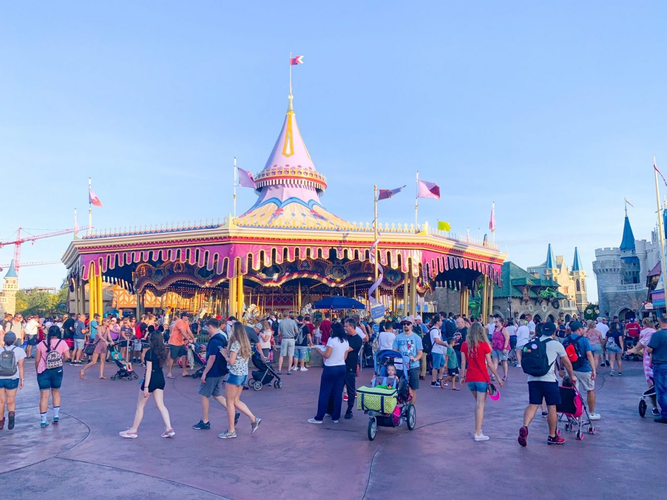 people walking in front of prince charming carousel