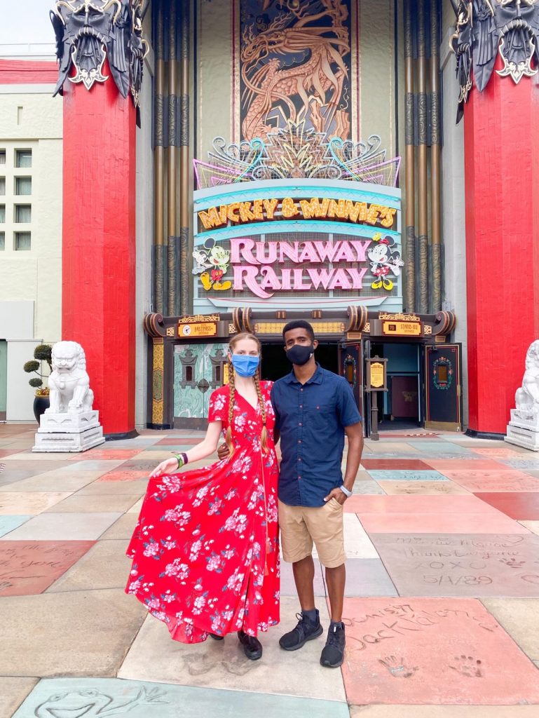 couple standing in front of Mickey and Minnie's Runaway Railway entrance