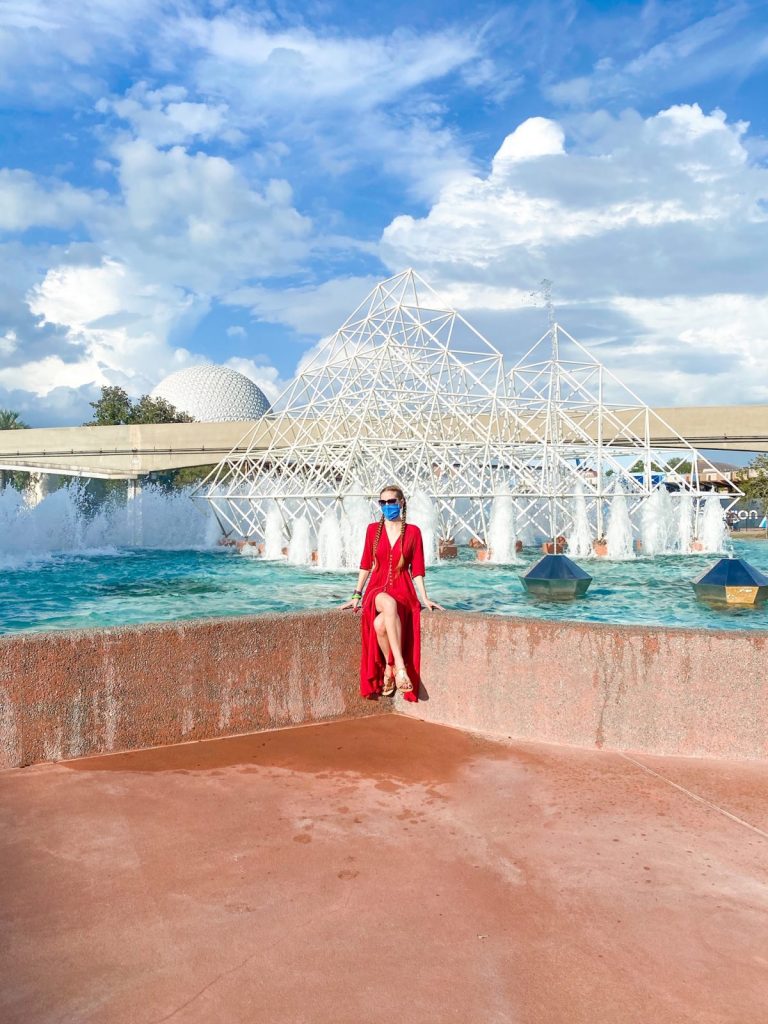 woman sitting in front of the fountain at Epcot