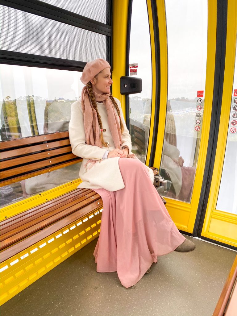 woman sitting on a december outfit for disney on the skyliner