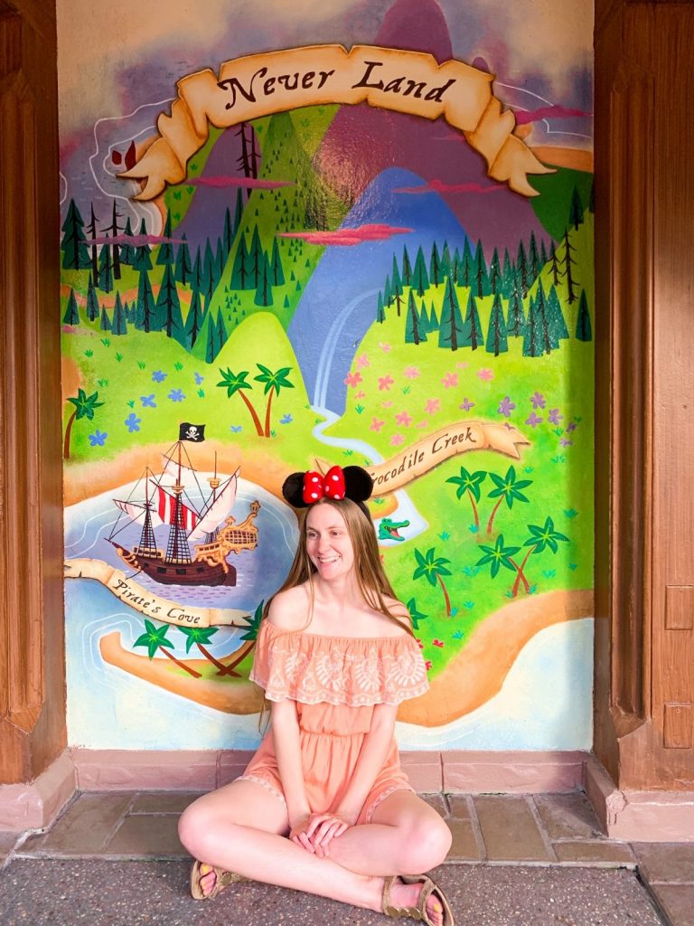 Disney Instagram captions in front of Peter Pan mural
