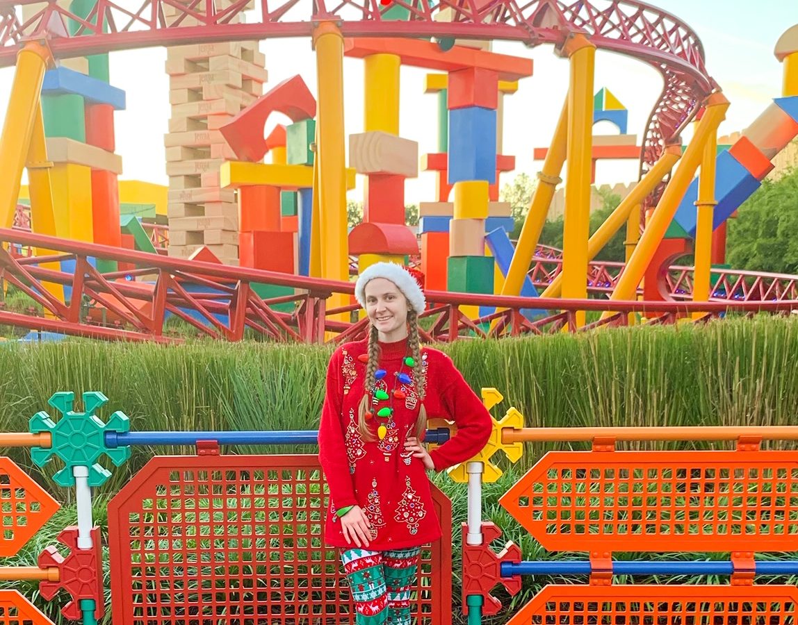 woman standing at hollywood studios in a christmas outfit and leggings