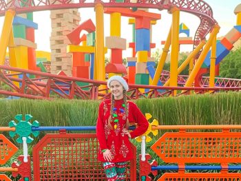 woman standing at hollywood studios in a christmas outfit and leggings