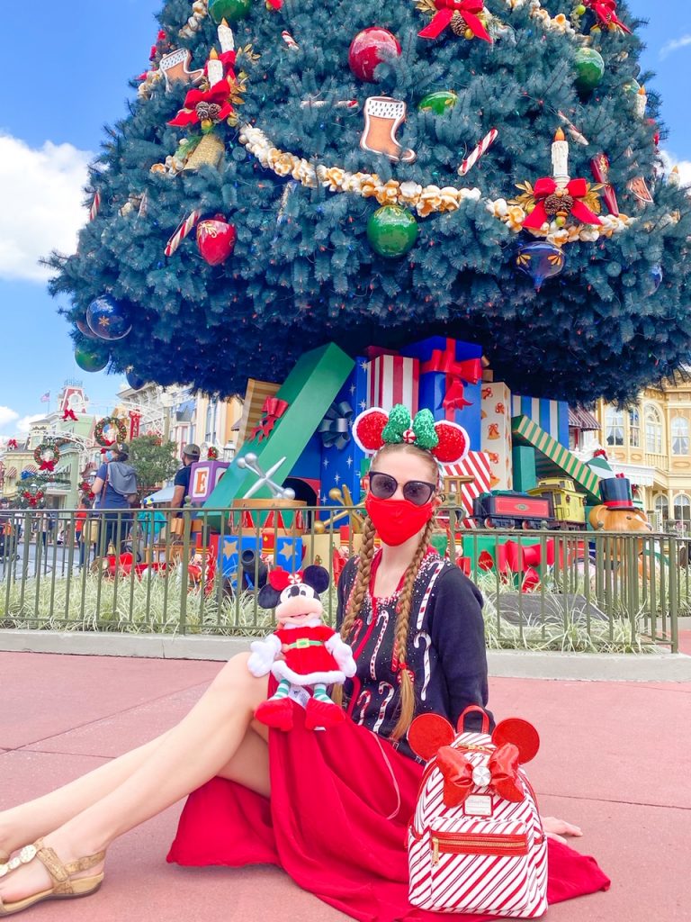 Disney Instagram captions in magic kingdom posing in front of Christmas tree