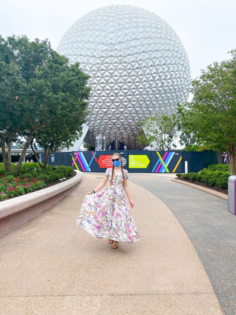 woman in front of spaceship earth