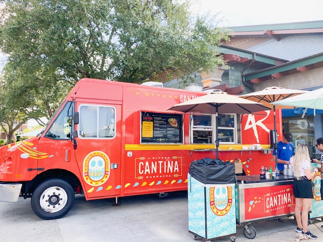 large red food truck with ordering podium